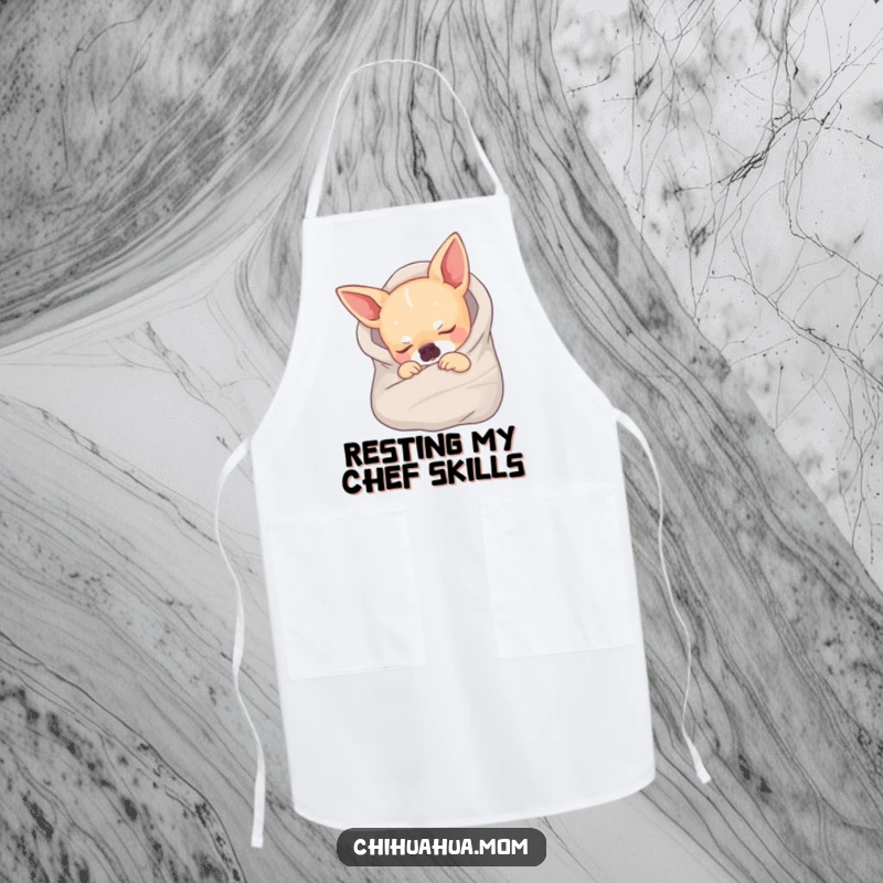 Funny apron showing a chihuahua wrapped in a tiny blanket, fast asleep, ideal for kitchen or relaxing.