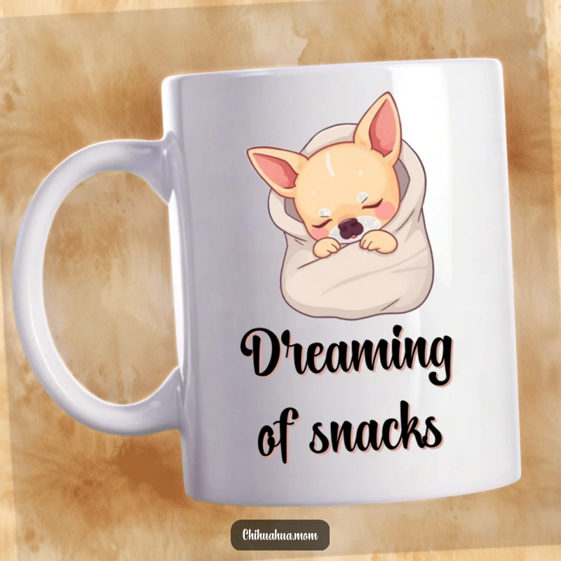 Funny mug showing a tiny chihuahua completely wrapped in a small blanket, sleeping soundly and looking incredibly cute.