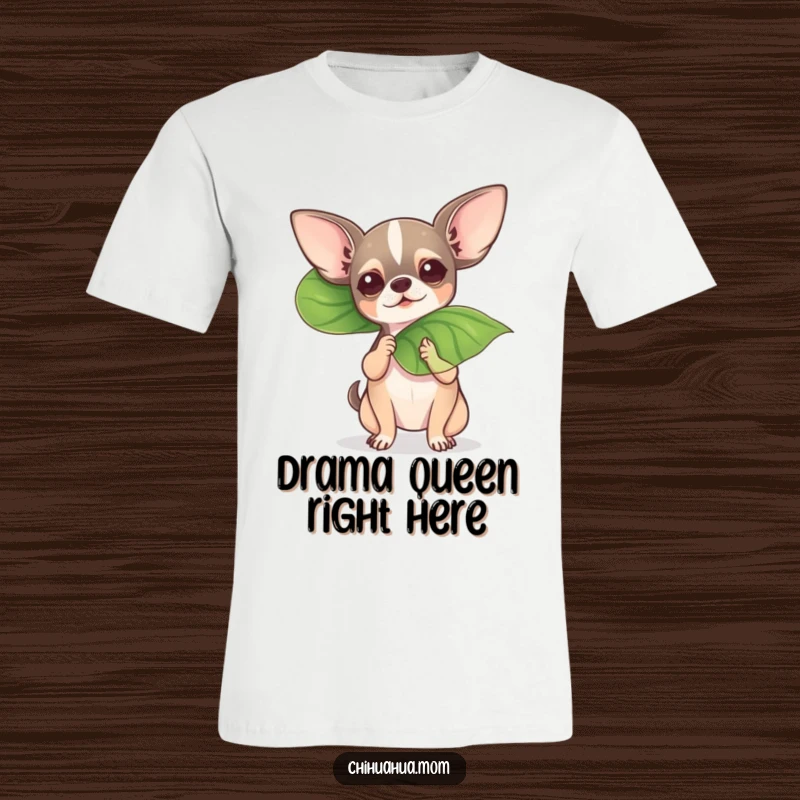 Funny chihuahua dramatically fanning itself with a large leaf, conveying heat and humor on a t-shirt.